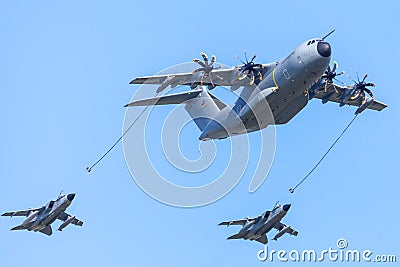 Military Airbus A 400 M transport plane flies with two Panavia Tornado multirole combat aircrafts Editorial Stock Photo