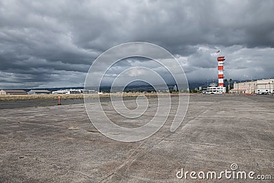 Military base airport runway with control tower. Stock Photo