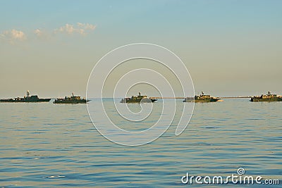 Military Battleships in a sea bay at sunset time. Stock Photo