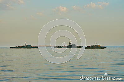 Military Battleships in a sea bay at sunset time. Stock Photo