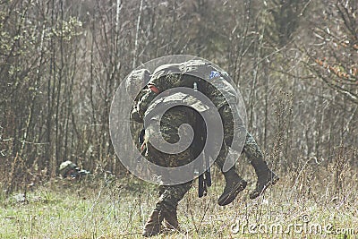 Military bear at back his wounded friend Stock Photo