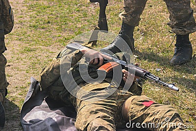 Military bear at back his wounded friend Stock Photo