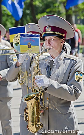 Military brass band. Female saxophone, performer Editorial Stock Photo