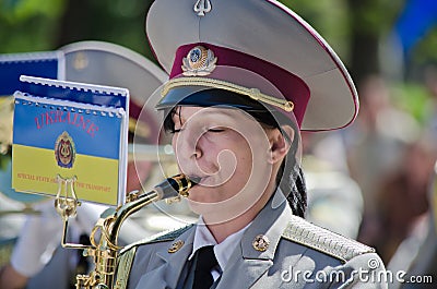 Military brass band. Female saxophone, performer Editorial Stock Photo