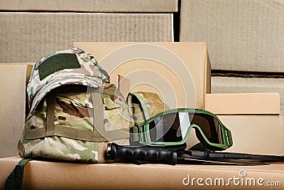 Military camouflaged armored helmet, cap and soldier googgles Stock Photo