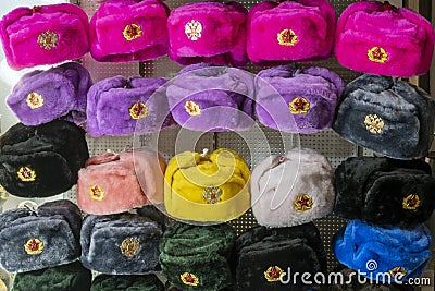 Military caps of different colors with the coats of arms of Russia and the USSR as Souvenirs from Moscow. Rows of russian winter Stock Photo