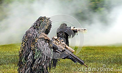 Commando dressed in ghillie camouflage during combat warfare Stock Photo