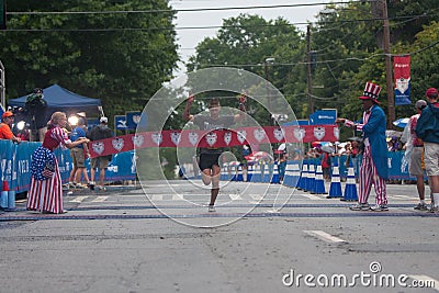 Military Competition Winner Breaks Tape At Atlanta 10K Road Race Editorial Stock Photo