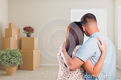 Military Couple Facing Empty Room with Packed Moving and Potted Stock Photo