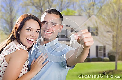 Military Couple with House Keys In Front of New Home Stock Photo