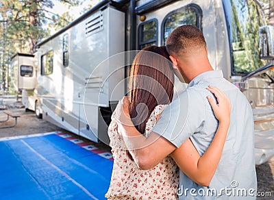 Young Couple Looking At A Beautiful RV At The Campground. Stock Photo
