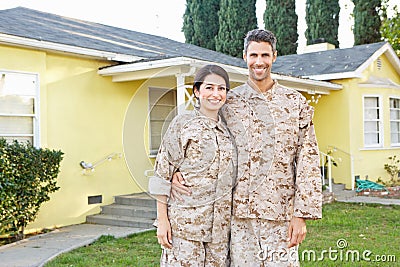 Military Couple In Uniform Standing Outside House Stock Photo