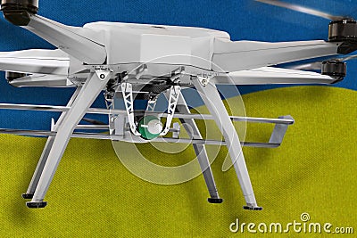 Military drones armed with bombs on a background of Ukrainian flag. Stock Photo