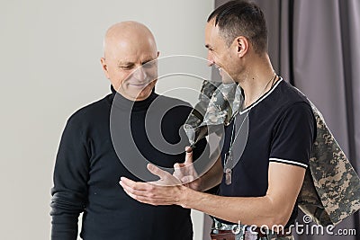 Military father hugs his son when they are reunited after a mission Stock Photo