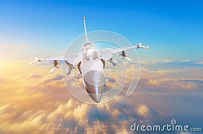 Military fighter aircraft at high speed, flying high in the sky sunset. Stock Photo