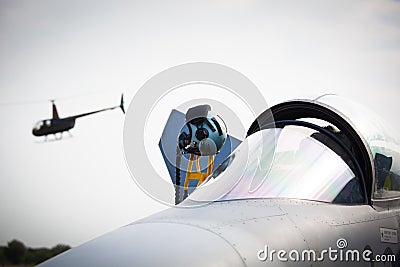 Military fighter and helicopter at military airport Stock Photo