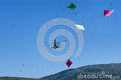 Military helicopter throws festive flyers Editorial Stock Photo