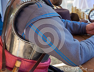 Military historical uniform reconstruction gray overcoat with blue stripes and cuirass Stock Photo