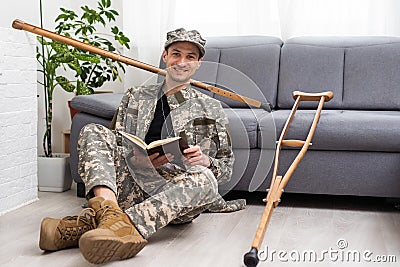military man with crutches, disability Stock Photo
