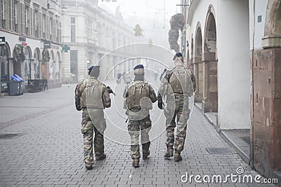 Military mens patroling in the street whit shotguns Editorial Stock Photo