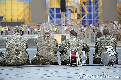 Military musicians sitting backs after parade, blurred people on a background Editorial Stock Photo