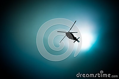 Military navy helicopter flying in the dark sky Stock Photo