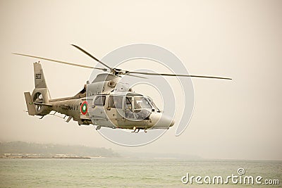 Military navy helicopter flying over sea Editorial Stock Photo