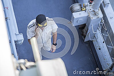 A Marine officer in uniform and a hat walking along the deck of a warship. Editorial use only. Burgas/Bulgaria/07.19.2018. Editorial Stock Photo