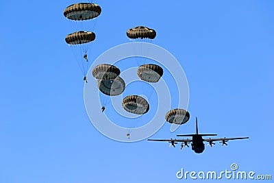 Military parachutist paratroopers jumping out of an air force airplane Editorial Stock Photo