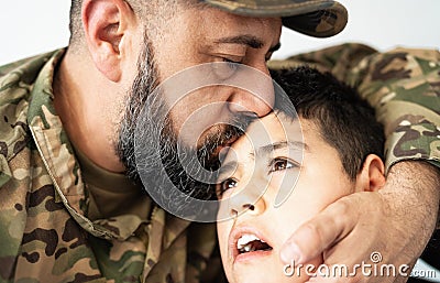 Military soldier kissing his son with disability at home Stock Photo