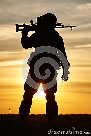 Military soldier silhouette with machine gun Stock Photo