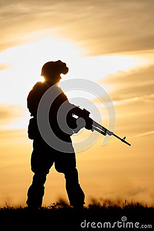 Military soldier silhouette with machine gun Stock Photo