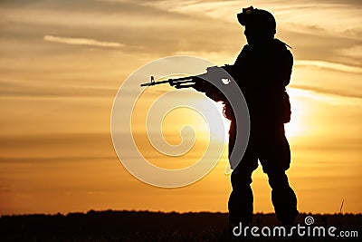 Military soldier silhouette with machine gun Stock Photo