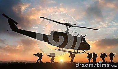 Military special force assault team helicopter drops during sunset Stock Photo