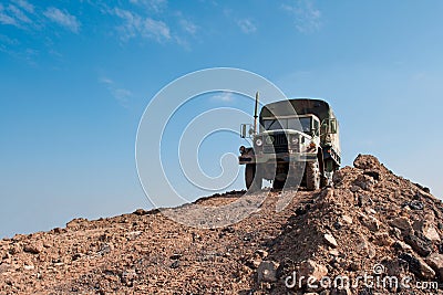 Military Truck on a Dirt Hill Stock Photo