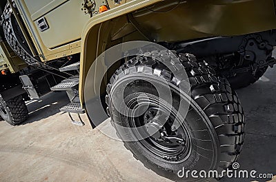 Military vehicle truck wheels on hub with black shine tires. New clean off road transport truck all terrain wheels for. High resol Stock Photo