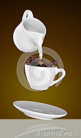 Milk being poured into small cup of coffee. 3d Stock Photo