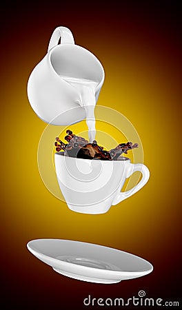 Milk being poured into small cup of coffee. 3d Stock Photo