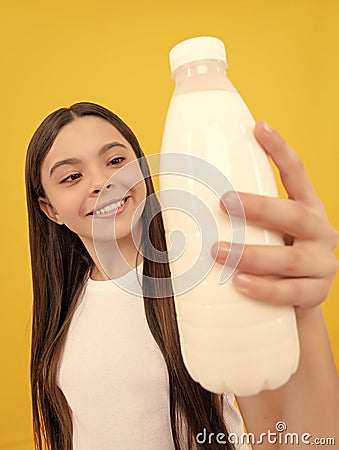 milk bottle in hand of happy child. kid hold dairy beverage product. Stock Photo