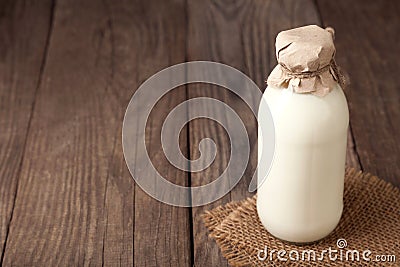 Milk bottle on wood table Stock Photo