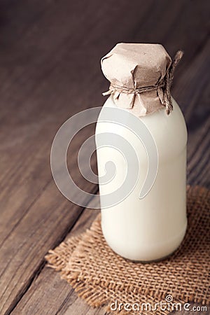 Milk bottle on wood table Stock Photo