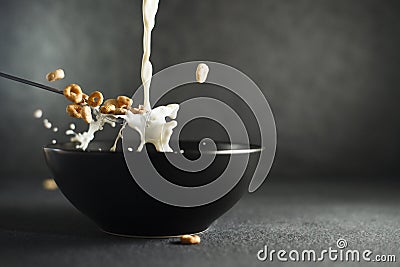 Milk and cereal splashing out of spoon Stock Photo