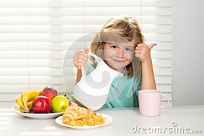 Milk for children. Fuuny little boy pouring whole milk for breakfast. Child boy eating organic healthy milk. Healthy Stock Photo