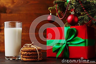 Milk, cookies and gifts under the Christmas tree. The concept of the arrival of Santa Claus Stock Photo