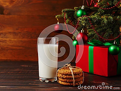 Milk, cookies and gifts under the Christmas tree. The concept of the arrival of Santa Claus Stock Photo