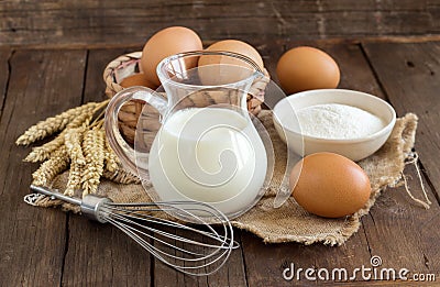 Milk, flour, wheat, whisk and eggs Stock Photo