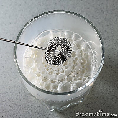 milk frother. frothed milk in a glass Stock Photo