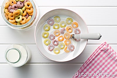 Milk with fruity cereal rings Stock Photo