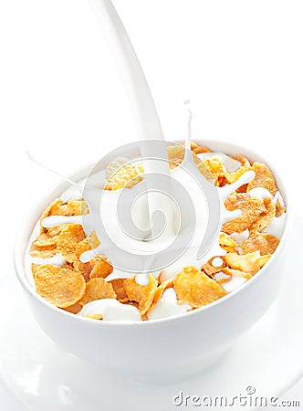 Milk pouring into a bowl of corn flakes Stock Photo