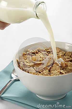 Milk pouring into cereal bowl Stock Photo